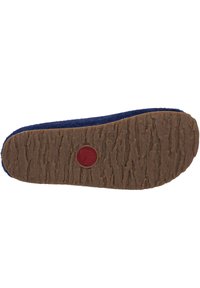 Sole of a navy felt shoe with a textured tan rubber outsole, featuring a red circular logo at the center, and a low-profile design.