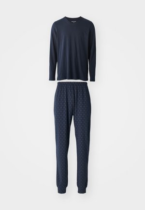 Granatowa bluzka z długim rękawem i dekoltem w kształcie litery V, w komplecie ze spodniami w dopasowanym wzorze, które charakteryzują się subtelny designem, elastycznym pasem oraz zwężającymi się mankietami.