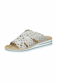 White slide sandals with cut-out floral design, featuring a textured upper, tan insole, and white striped sole.