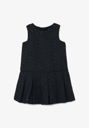 Robe noire sans manches avec un corsage ajusté et une jupe plissée, présentant des pois argentés et une fermeture éclair au dos. Texture du tissu lisse.