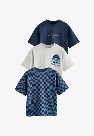 Drie graphic T-shirts weergegeven: één marineblauw met tekst, één crèmekleurig met een illustratie, en één met een blauw ruitpatroon. Van katoenmix.
