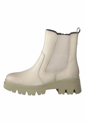 Bottine en cuir beige avec des panneaux latéraux élastiques, des surfaces texturées et une semelle en caoutchouc épaisse. Dispose d'une languette pour un enfilage facile.