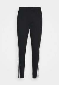Pantalons de sport noirs à coupe ajustée, avec des bandes blanches sur les côtés, une taille élastique et une texture de tissu douce.