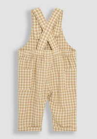 Rutig beige byxoverall med korslagda axelband, två framfickor och ett lätt strukturerat tyg.