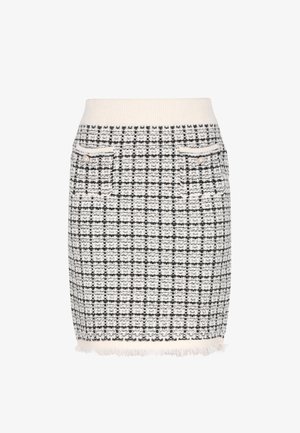 Tweed nederdel i creme- og sort ternet mønster, med en strikket talje, to foranlommer og en frynset kant.