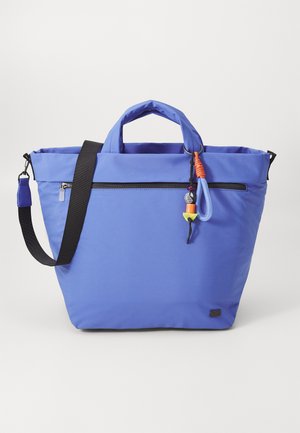 Blue tote bag with a zippered pocket, fabric material, two handles, and an adjustable strap. Features colorful accents attached to the zipper.