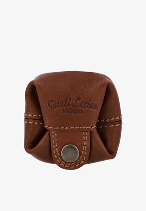 Brown leather coin pouch with flap and metal snap button, featuring stitched edges and embossed "Gusti Leder studio" logo.