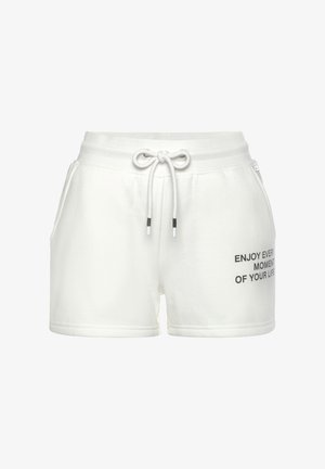 White cotton shorts with an elastic waistband, drawstring, and side pockets. Features printed text in black on the lower left side.