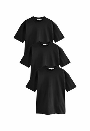 Camisetas de algodón negras, apiladas verticalmente en tres, con mangas cortas y diseño de cuello redondo. Textura suave, sin patrones ni acentos visibles.