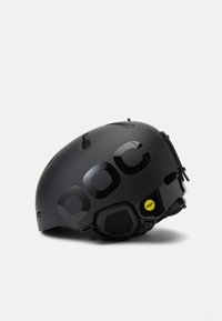 Fekete sí sisak fényes akcentusokkal, szellőzőnyílásokkal a tetején, párnázott belsővel, és egy sárga MIPS matrica az oldalán a hatásvédelmi védelemért.