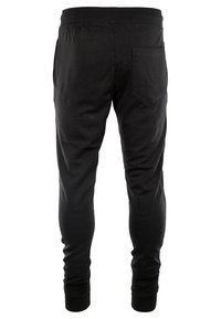 Sorte bomuldsbukser med en tapered design, der har en elastisk talje og en enkelt baglomme. Glat tekstur og elastiske manchetter ved anklerne.