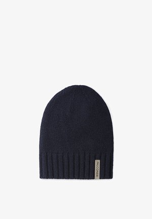 Bonnet en tricot bleu marine avec ourlet côtelé et petite étiquette rectangulaire de la marque Falconeri sur le bord.