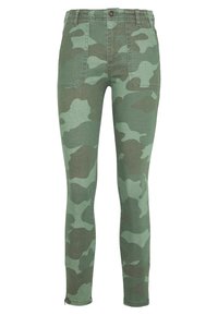 Pantalones ajustados con un patrón de camuflaje en verde y verde oscuro, grandes bolsillos frontales de parche, cierre de botón y cremalleras en los tobillos.