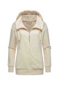 Hoodie crème avec une fermeture éclair complète, une capuche à cordon de serrage, des manches longues et des poignets côtelés. Présente un petit logo sur la poitrine et une texture douce.