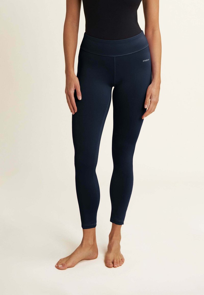 Leggings bleu marine avec une taille haute, fabriqués dans un tissu extensible, dotés de coutures plates et d'une coupe ajustée qui s'étend jusqu'aux chevilles.