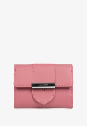 Pink leather wallet with a flap closure, featuring a silver metallic latch and a pointed accent. Smooth texture and stitched detailing visible.