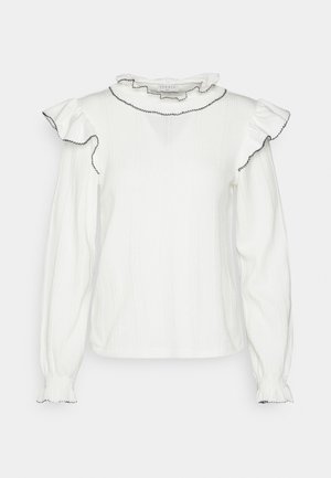 Hvid langærmet bluse med flæsekrave og skulderdetaljer, sorte kantdetaljer på kanterne og elastiske manchetter.