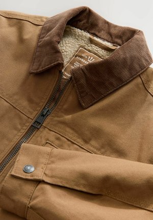 Brown canvas zip-up jacket with corduroy collar, fleece lining, and snap-button accent on the sleeve. Features sturdy stitching details.