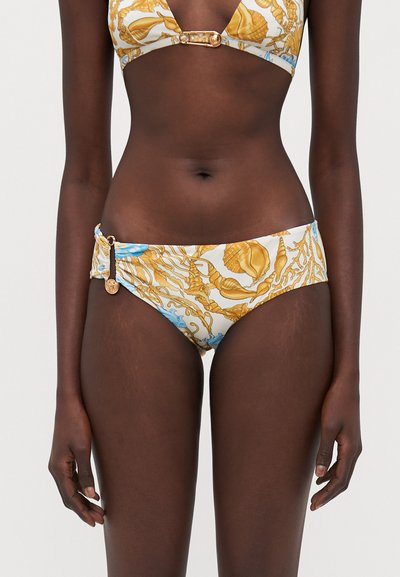 Bikini with a nautical pattern in gold and blue on a white background. The bottoms feature a gathered design and a gold hardware accent.
