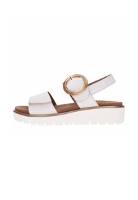 White leather sandal with two front straps, circular accent, and adjustable slingback. Features a textured white platform sole.