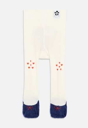 Collant per bambini color crema con grappoli di cuori rossi sulle ginocchia, piedi morbidi blu marina con fiocchetti rossi e un piccolo tag a forma di faccina di panda in vita.