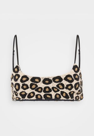 Kreklu ar pērļu apdari, kas izceļ leopardu rakstu ar melnām, zelta un bēšām pērļu krāsām. Tam ir plāni melni regulējami siksnas.