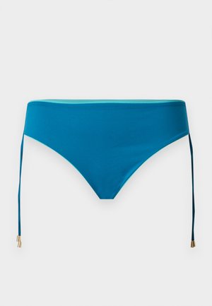 Modré dámske bikiny dole s bočnými zväzkami končiacimi zlatistými kovovými koncami na jednoduchom bielom pozadí.