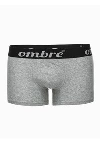 Boxers grises con una cintura elástica negra que presenta el nombre de la marca "ombre" en letras blancas. Textura suave y diseño ajustado.