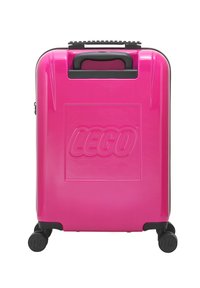 Pink hard-shell suitcase with a prominent LEGO logo, black accents, and four swivel wheels for mobility. Features a textured grip handle.