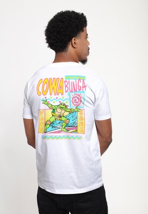 White cotton t-shirt featuring a graphic design on the back with vibrant colors: "COWABUNGA," a surfing turtle, and geometric accents.