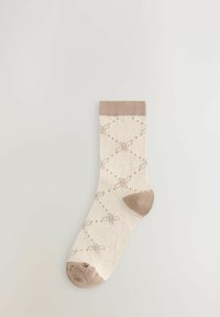 Beige Socken mit gemustertem Design, das hellbraune Schleifen und Punkte zeigt. Der Bund ist einfarbig hellbraun, mit verstärkter Zehen- und Fersenpartie.
