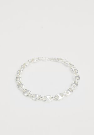 Silver chain necklace featuring linked, textured oval shapes with a shiny finish. Secure clasp closure at the back.
