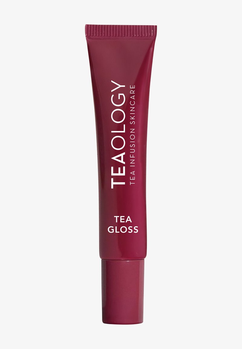 Tubetto bordeaux di Teaology Tea Gloss, dal design elegante. Il testo bianco mostra il nome del marchio e del prodotto, in modo prominente con una finitura lucida.