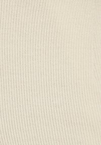 Rippstrickstoff in Off-White, mit feinen vertikalen Streifen und einer weichen, strukturierten Optik. Geeignet für Bekleidung oder Accessoires.