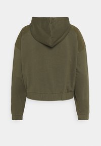 Felpa cropped verde oliva con maniche lunghe, cappuccio e polsini e orlo a coste, vista da dietro su uno sfondo bianco.