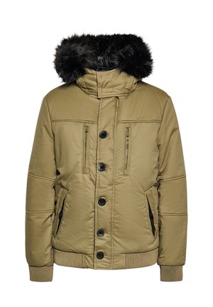 Beige gewatteerde winterjas met zwarte bontvoering in de capuchon, knopen aan de voorkant, gezipte borstzakken en geribde boorden en zoom.