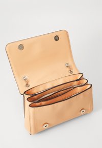 Peach textured leather clutch with three compartments, gold hardware, and snap closures. Interior features a smooth fabric lining.