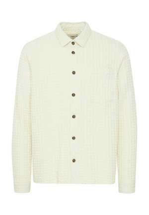 Witte overhemd met knoopjes, gemaakt van gestructureerde stof. Voorzien van een borstzak, een puntige kraag en houten knopen langs de voorkant.