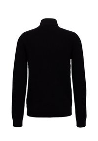 Svart ribbad tröja med hög krage, långa ärmar och ett texturerat mönster genom hela plagget. Inga synliga logotyper eller detaljer.