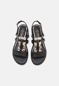 Black leather sandals with a slingback design, featuring a gold-accented leopard print panel and two black straps across the foot.