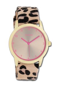 Montre ronde avec un boîtier doré, un cadran rose et un bracelet en suède à imprimé léopard. Elle dispose d'index des heures minimalistes et d'aiguilles des heures et des minutes roses.