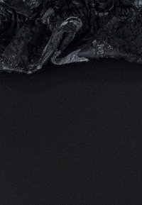Black fabric with a smooth texture at the bottom; gathered black lace at the top with a shiny finish and subtle pattern.
