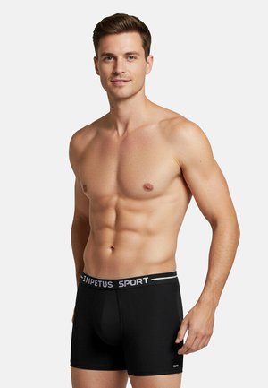 Boxer sportivi neri con una fascia in vita bianca recante la scritta "IMPETUS SPORT." Il design è aderente, realizzato in tessuto liscio e include una tasca anteriore.
