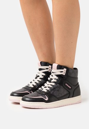 High-top sneakers in black leather and fabric, featuring a pink accent, white laces, and a logo on the side. Textured surface and padded collar.