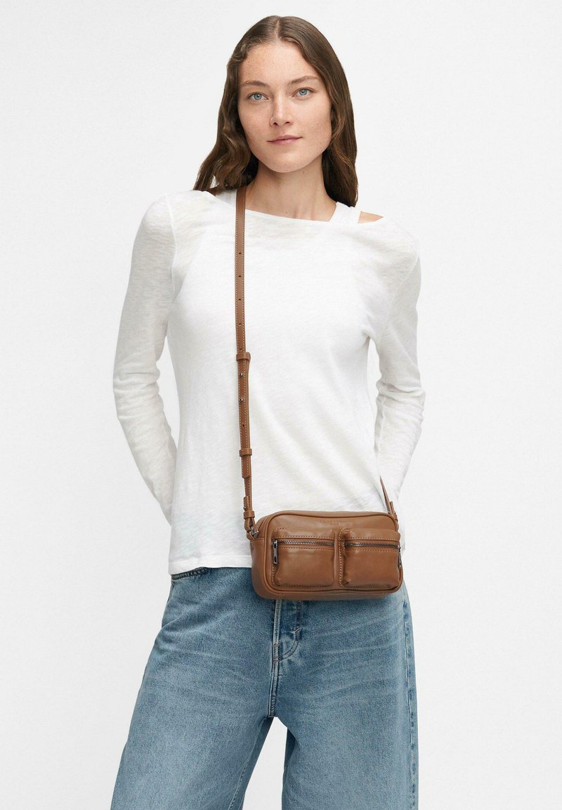 Borsa a tracolla in pelle marrone con due tasche con zip, forma piatta, texture liscia e una tracolla regolabile e staccabile.