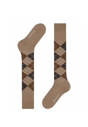 Braune knielange Socken mit einem Rautenmuster in Beige, Dunkelbraun und Schwarz sowie kleinen weißen Punkten, die Diamanten bilden.