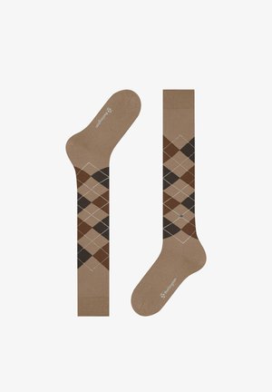 Braune knielange Socken mit einem Rautenmuster in Beige, Dunkelbraun und Schwarz sowie kleinen weißen Punkten, die Diamanten bilden.