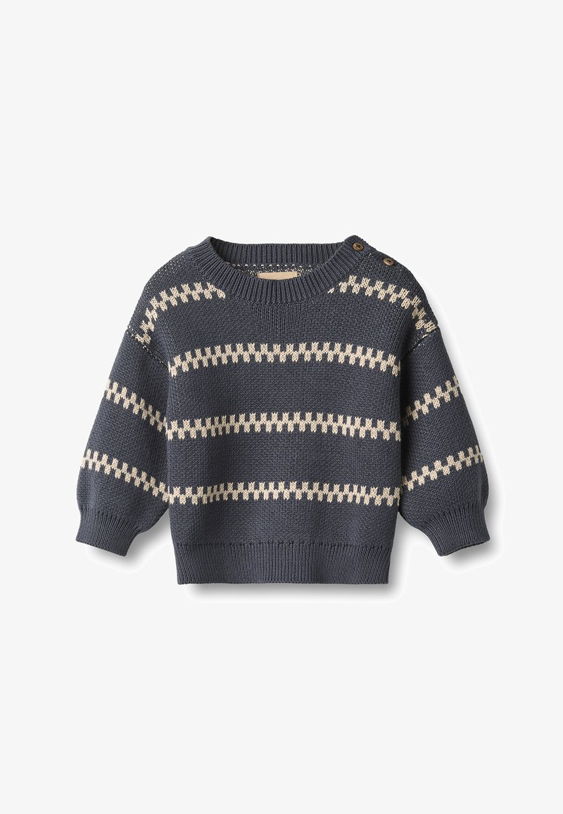 Pull bébé tricoté bleu foncé avec des rayures zigzag horizontales crème et deux boutons sur une épaule.