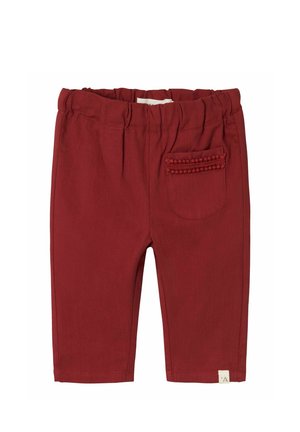 Pantalons en coton rouge avec une taille élastique, dotés d'une poche arrière avec des pompons décoratifs et d'une coupe droite.