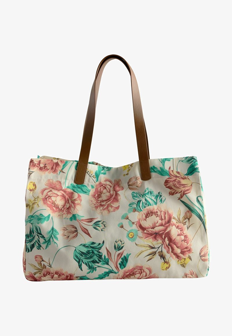 Sac en toile avec un motif floral en rose et bleu-vert, doté de poignées en cuir marron et d'une forme rectangulaire structurée.